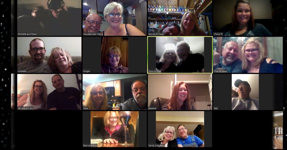 Grid of people on a Zoom call smiling and chatting from home showing virtual connection across multiple households.