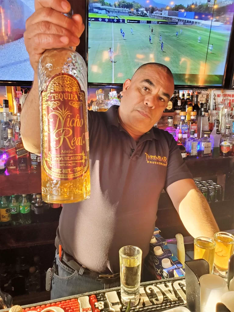 Rocky Point Mexico Rv Parks: Ultimate Guide 2025 19 Bartender holding a bottle of tequila.