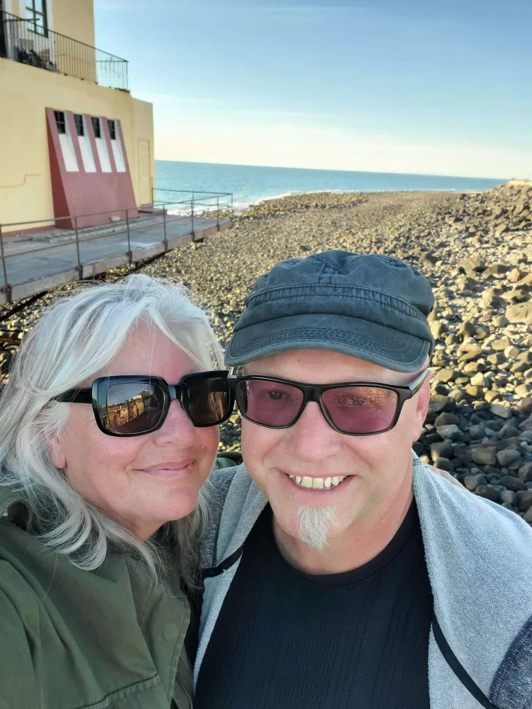 38 Super Fun Things To Do In Puerto Penasco 2025 224 Couple standing on beach with blue water behind them.