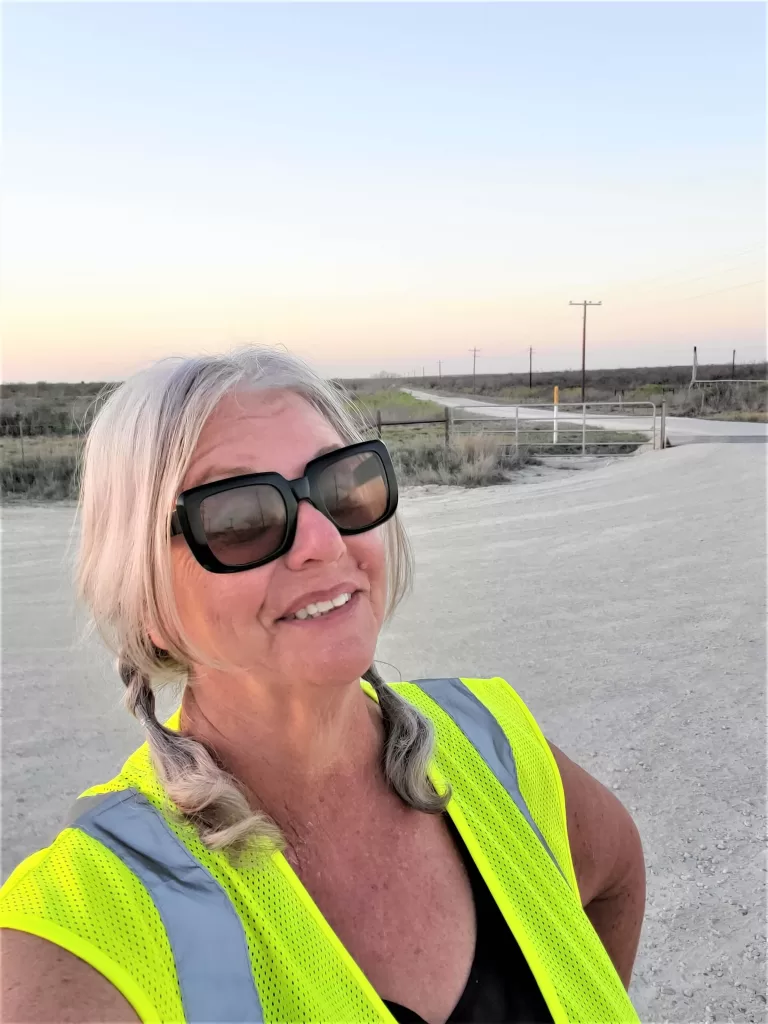 Gate Guarding: Work Camping Jobs For Full-Time Rvers 2024 15 Female gate guard wearing safety vest.