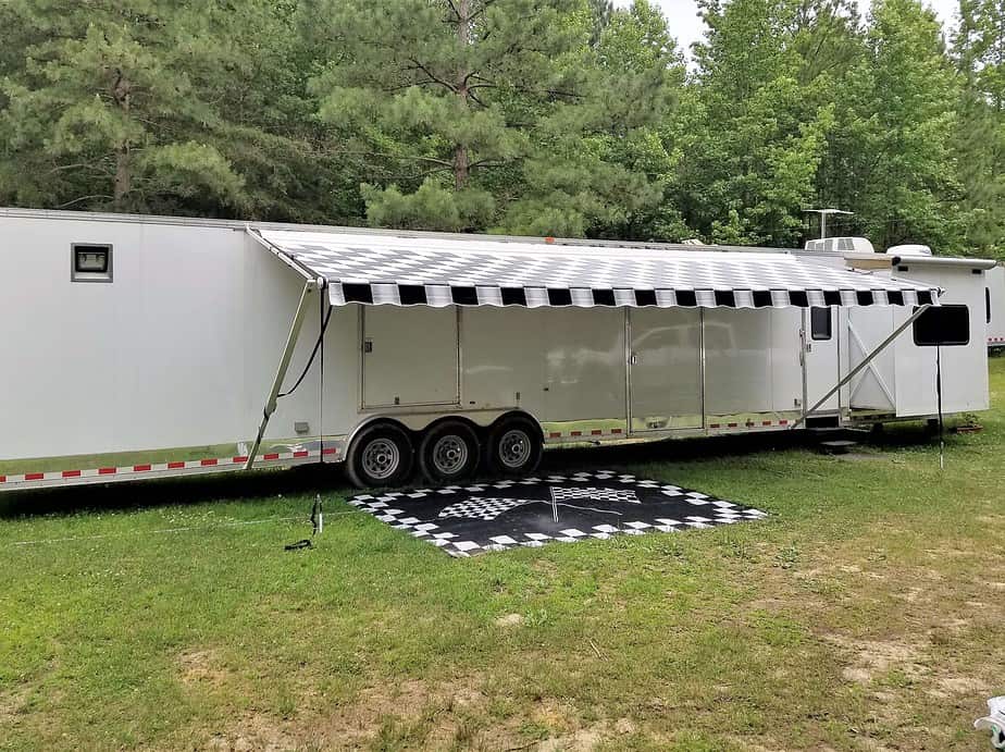 Full-Time Rv Living For Beginners: Start Here! 6 52 foot white racecar trailer with awning.
