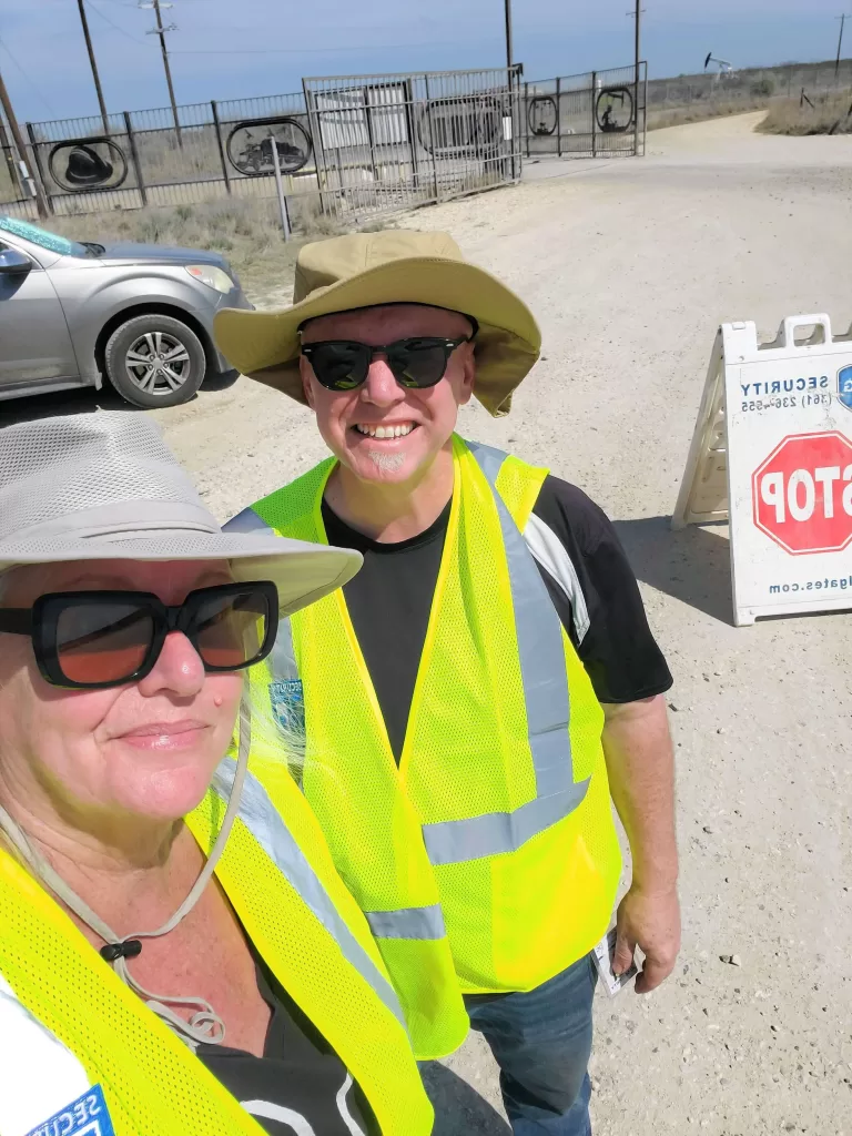 Gate Guarding: Work Camping Jobs For Full-Time Rvers 2024 2 Happy rv couple working as gate guards.
