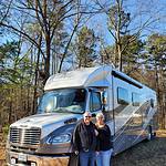 The stromads, an rving couple standing in front of their renegade verona super c rv.