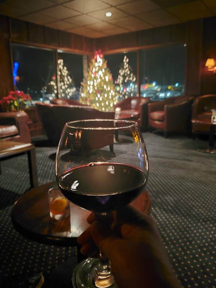 Red wine in a soft lighted speakeasy at christmas.