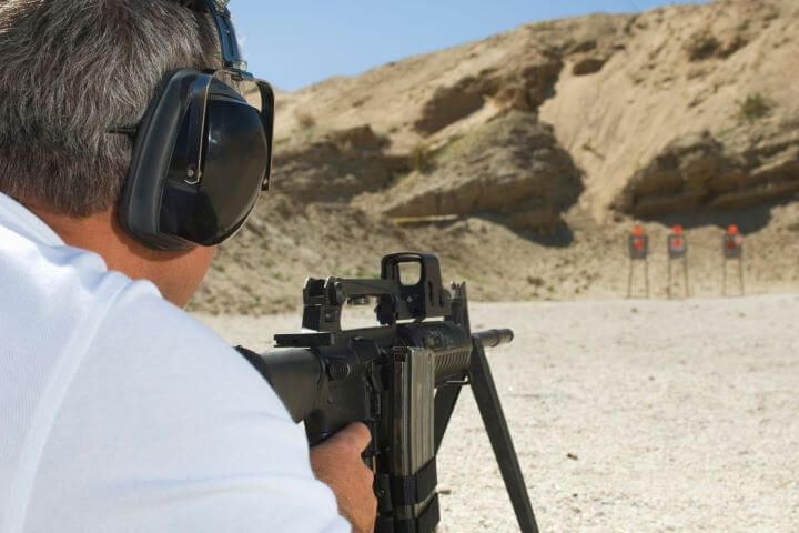 40+ Fascinating Things To Do In Vegas Besides Gamble 2024 16 Man shooting machine gun at targets in a desert