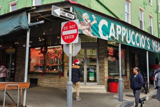 Best Campgrounds Near Philadelphia, Pa For 2025 24 Urban street scene at philadelphia's italian market with pedestrians walking past capuccio's meats, highlighted by vibrant signage and street signs indicating 'one way' and 'do not enter' at the intersection.