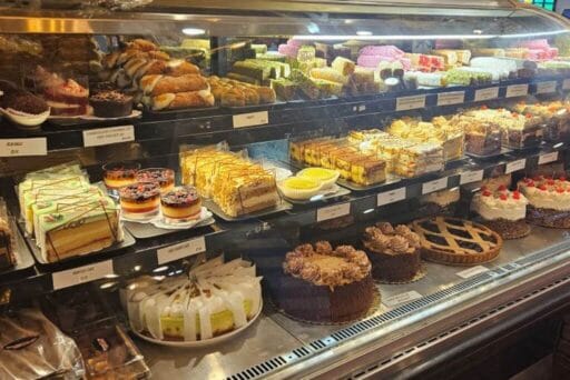Rv Friendly Campgrounds Near Washington, Dc 2025 14 The image shows a bakery display case filled with an assortment of cakes, pastries, and desserts. The shelves are packed with a variety of sweets, including layered cakes, cream-topped pastries, fruit tarts, and cheesecakes, each meticulously arranged and labeled with price tags. The vibrant colors and diverse textures of the desserts make the display visually appealing, inviting customers to indulge in a range of baked goods.