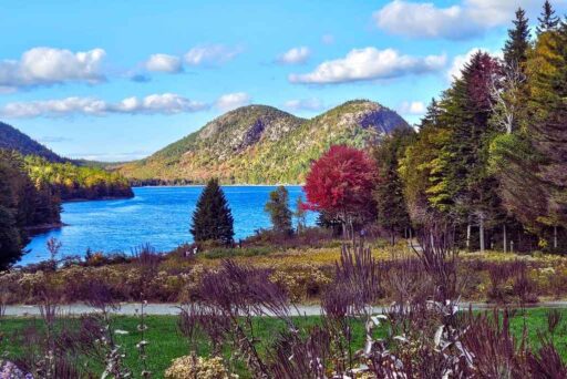 The Ultimate Acadia National Park Itinerary For 2025: Your Perfect 3-Day Plan 2 Jordan pond in acadia national park, with clear blue water, twin mountains, and vibrant autumn foliage under a bright sky.