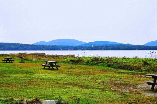 Beaches In Acadia National Park: More Than Just Sand 22 Picnic tables on a grassy field at lamoine state park, overlooking the calm waters and distant hills