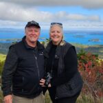 Beaches In Acadia National Park: More Than Just Sand 28 Robb strobridge and maureen wright smiling atop a scenic mountain with ocean and islands behind them