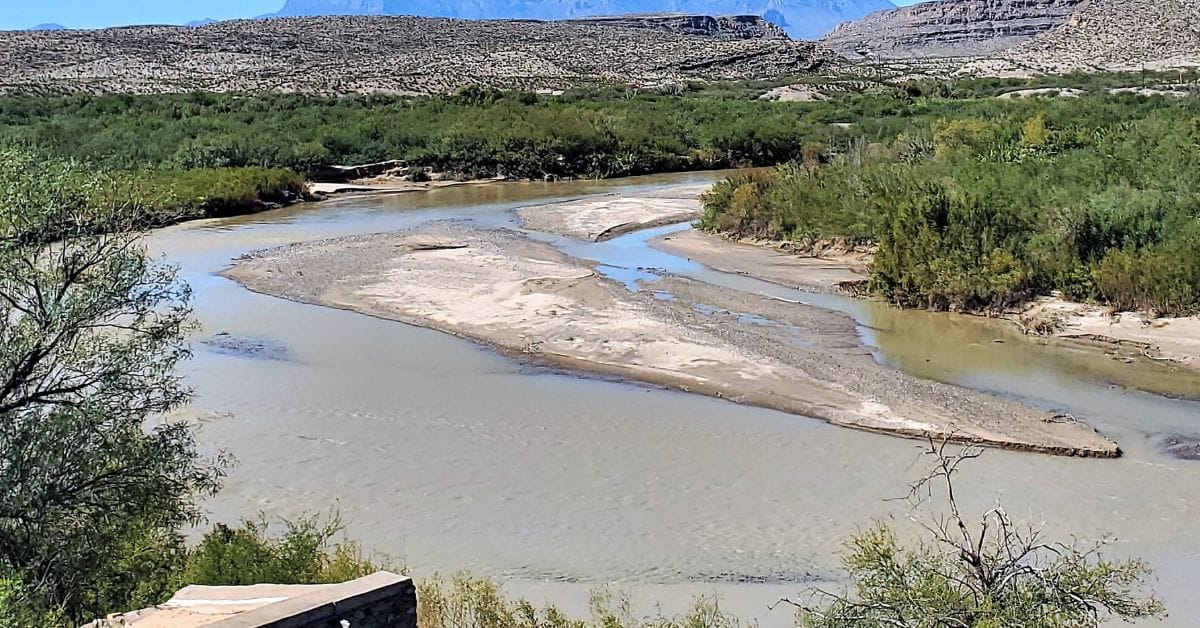 Boquillas-Mexico Boquillas river bend with desert landscape and green brush.