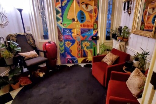 30 Best Things To Do In Batavia, Ny In 2025 7 Colorful, modern art-filled room at go art! Gallery in batavia, ny, with bold door mural, red chairs, and lush indoor plants.