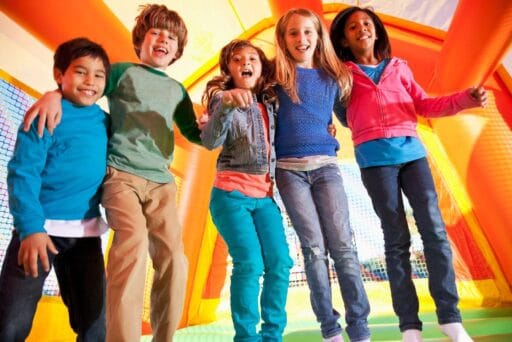 30 Best Things To Do In Batavia, Ny In 2025 21 Smiling kids jumping together inside a colorful bounce house at house of bounce in batavia, ny, enjoying an active indoor play day.