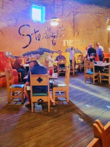 11 Fun Things To Do In Terlingua You Can’t Miss In 2025 17 Diners seated at rustic wooden tables inside the colorful, eclectic starlight theatre restaurant with mural-style wall art.