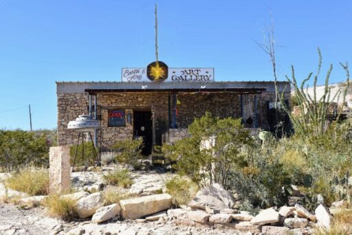 11 Fun Things To Do In Terlingua You Can’t Miss In 2025 9 Stone building housing earth & fire art gallery in terlingua, texas, with ufo sculpture and desert plants out front.