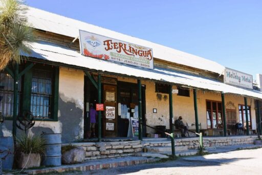 11 Fun Things To Do In Terlingua You Can’t Miss In 2025 2 Rustic terlingua trading company storefront with weathered walls, porch seating, and signs for gifts, jewelry, and books.