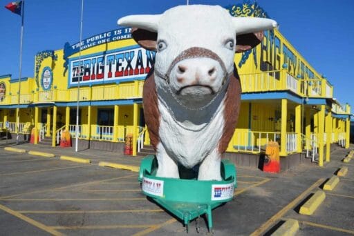 17 Weird Things To Do In Amarillo (2025) 13 Giant steer statue in front of the colorful big texan steak ranch, a must-see roadside eatery among things to see in amarillo.
