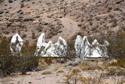 Ghostly Sculptures At The Goldwell Open Air Museum In Nevada White shrouded ghost sculptures stand in a desert landscape at a remote roadside attraction in nevada.