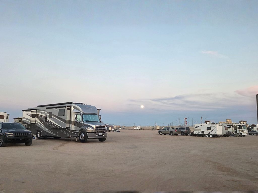 Rvs parked on open sand at concha del mar in rocky point mexico under soft sunset sky near beachfront rv parks in rocky point mexico.