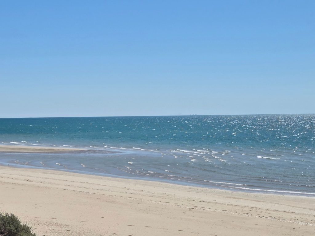 Quiet estuary beach in puerto peñasco with gentle waves and sandy shoreline, a peaceful escape among things to do in puerto penasco.