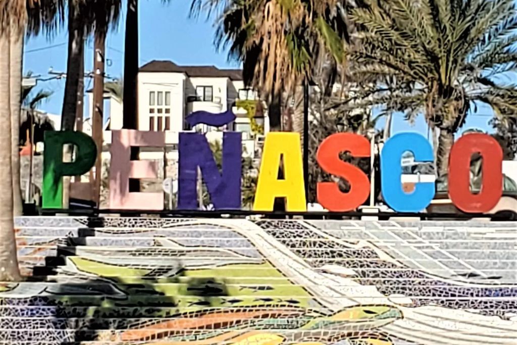 Colorful "penasco" sign above mosaic steps with palm trees in rocky point puerto penasco mexico.