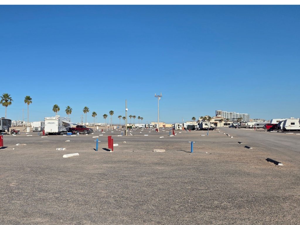 Wide layout of rv sites at the reef rv park in rocky point mexico with spaced hookups palm trees and open campground design.