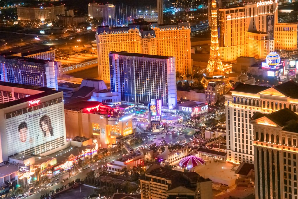 Aerial view of Las Vegas Strip at night with Paris Eiffel Tower and bright casino lights