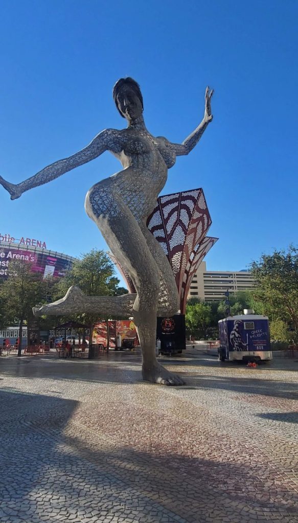 Bliss dance sculpture standing outdoors near the las vegas strip.