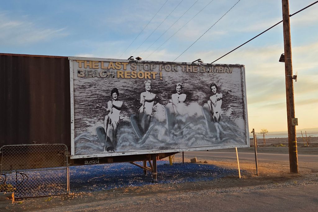 Visiting The Salton Sea: California’s Strangest Desert Lake 15 Vintage bombay beach resort billboard beside the salton sea at sunset in california desert.