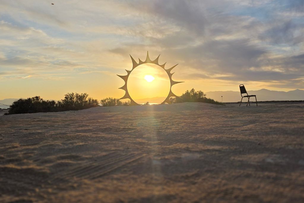 Visiting The Salton Sea: California’s Strangest Desert Lake 5 Sunset glowing through metal art sculpture at bombay beach beside the salton sea in california.