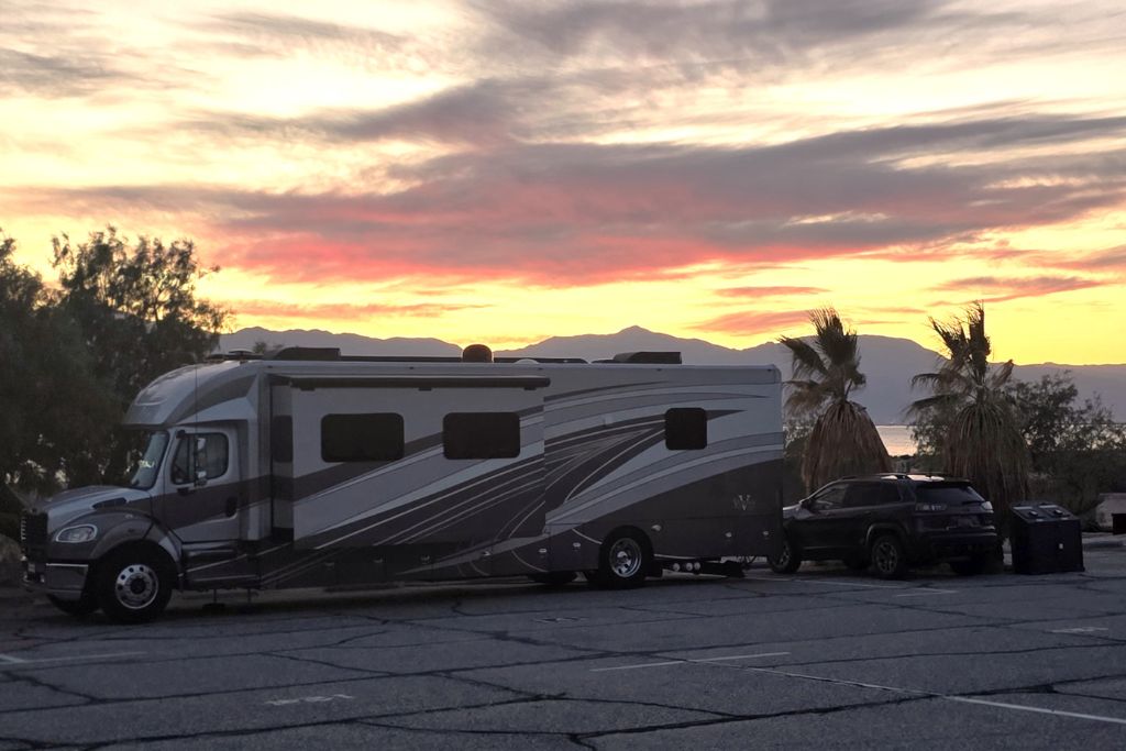 Visiting The Salton Sea: California’s Strangest Desert Lake 14 Rv parked near the salton sea at sunset with palm trees and glowing desert skies.