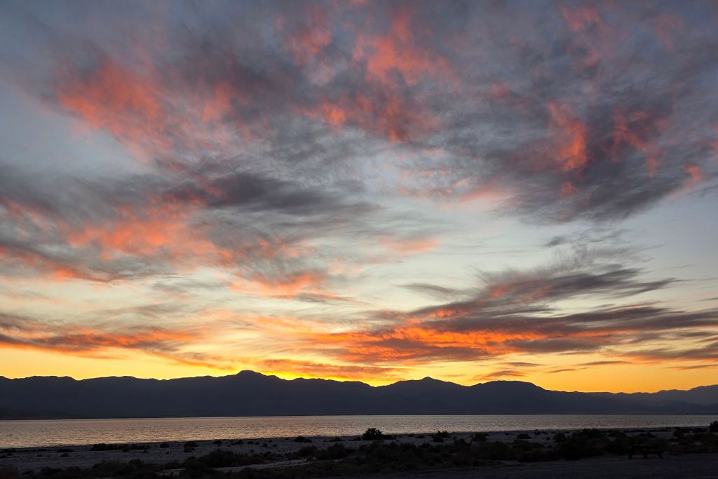 Visiting The Salton Sea: California’s Strangest Desert Lake 12 Colorful sunset clouds over the salton sea with mountain silhouettes along the california desert horizon.