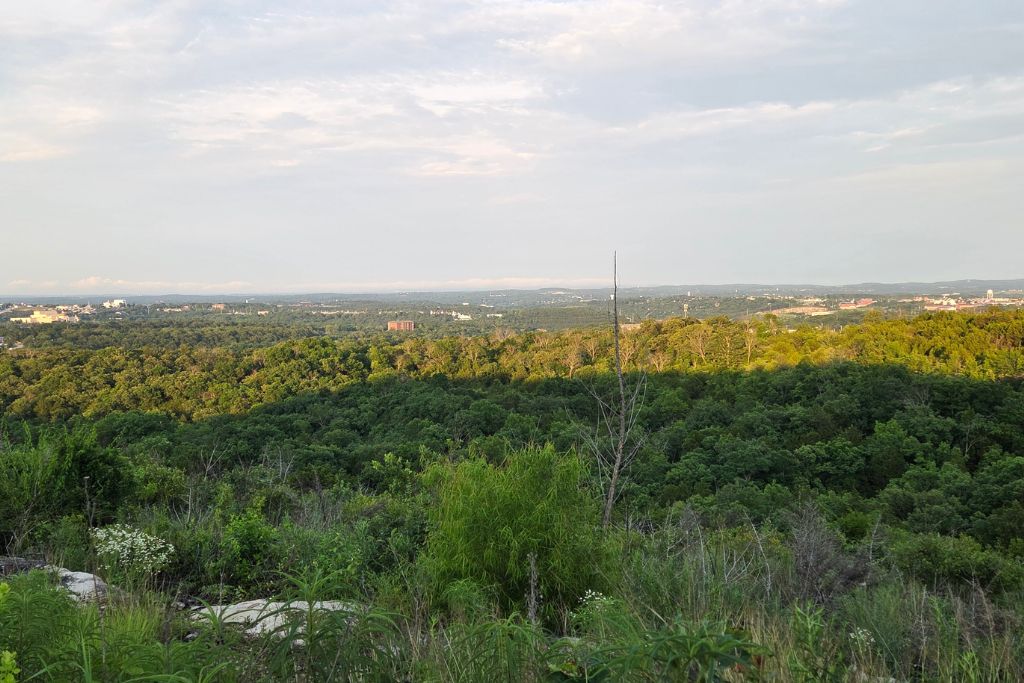 Missouri Road Trip Itinerary: Branson, The Ozarks &Amp; Beyond 25 A panoramic overlook reveals rolling forested hills surrounding branson, missouri, as evening sunlight breaks through the clouds.