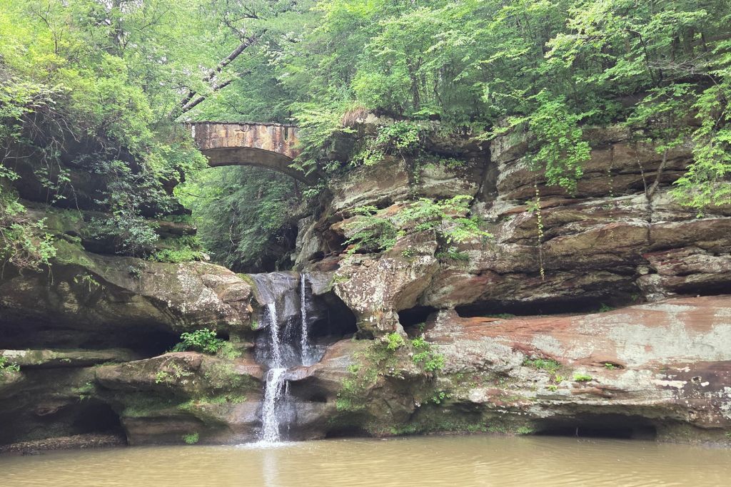 Missouri Road Trip Itinerary: Branson, The Ozarks &Amp; Beyond 2 Waterfall cascading into old man's cave at hocking hills, a scenic stop on our missouri road trip.