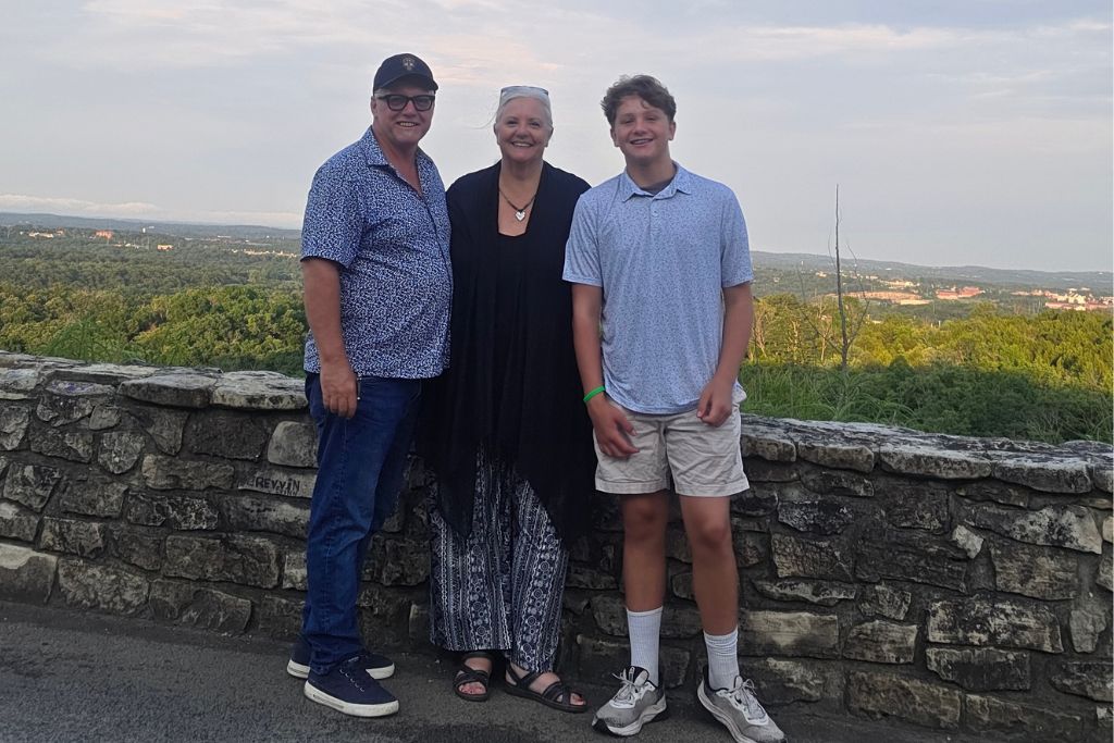 Missouri Road Trip Itinerary: Branson, The Ozarks &Amp; Beyond 29 Maureen and robb stand with their grandson mason at a scenic overlook near branson missouri after a family rv road trip filled with new experiences and shared memories.