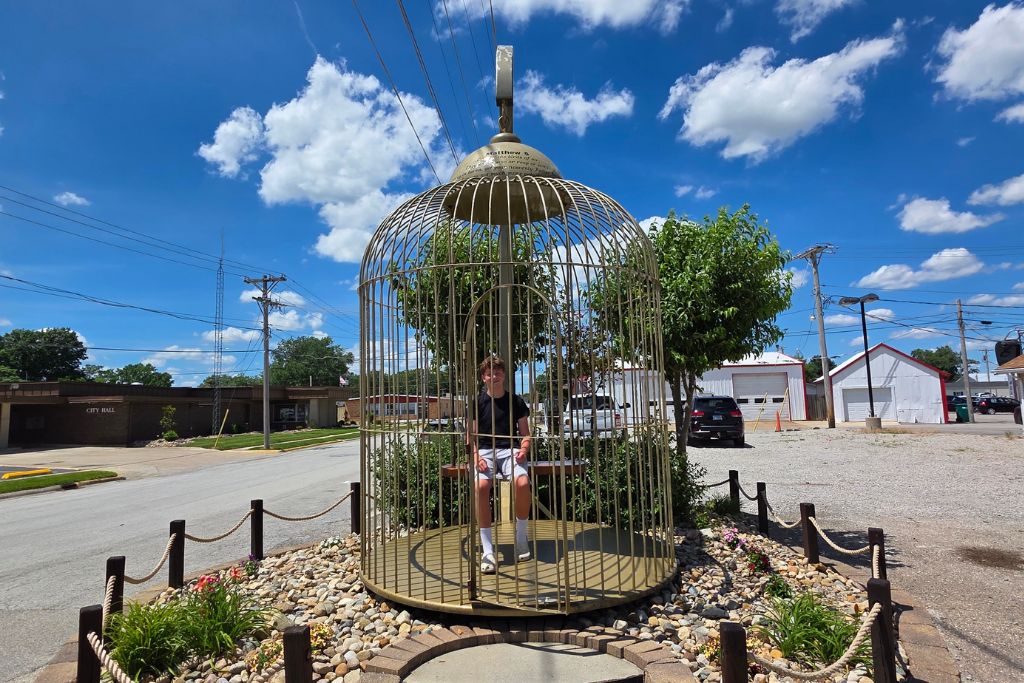Missouri Road Trip Itinerary: Branson, The Ozarks &Amp; Beyond 6 Mason sitting inside the world's largest bird cage in casey, illinois.