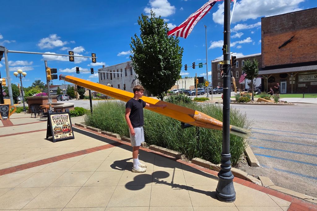 Missouri Road Trip Itinerary: Branson, The Ozarks &Amp; Beyond 5 Mason posing beside the world's largest pencil in casey, illinois, during our missouri road trip.