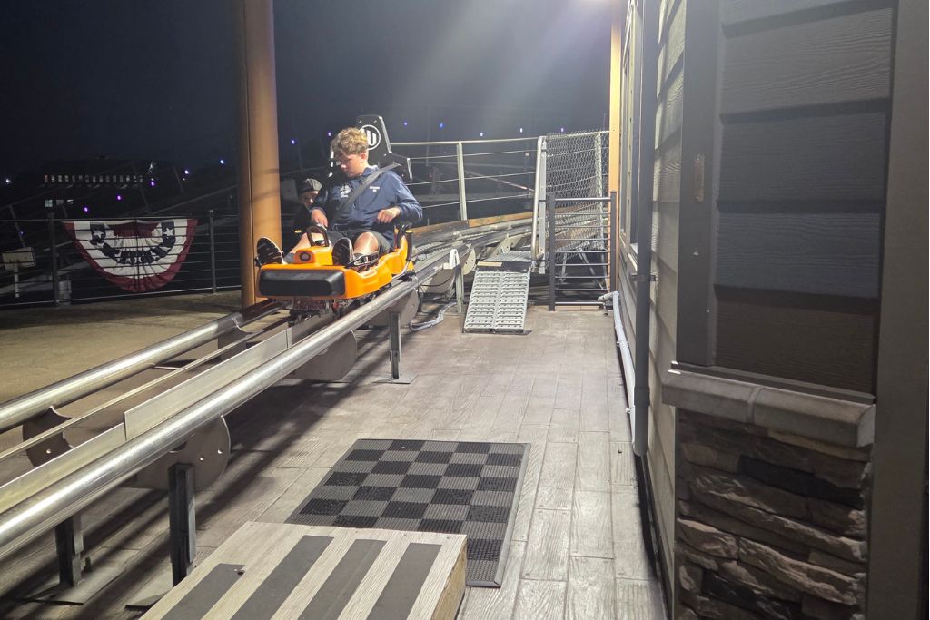 Is Branson Worth Visiting? Our Thoughts After Three Days 3 Mason prepares to ride the branson coaster at night, seated in the mountain coaster car before descending the track. The alpine coaster was one of our favorite attractions and a fun answer to the question, is branson worth visiting.