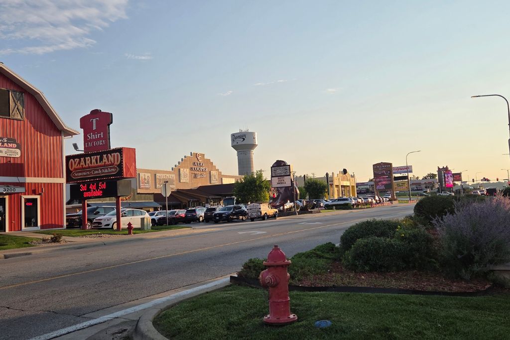 Is Branson Worth Visiting? Our Thoughts After Three Days 8 A wide street lined with attractions, restaurants, and souvenir shops in branson's entertainment district. Many of the attractions are spread out with large parking lots between them, making driving the easiest way to explore.