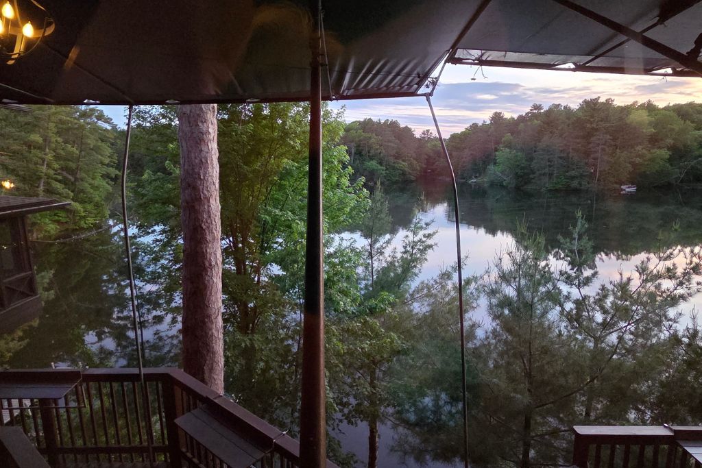 Wisconsin Dells For Adults: Beyond The Waterparks 14 Mirror lake reflecting the soft pink and blue sunset through the trees at ishnala supper club.