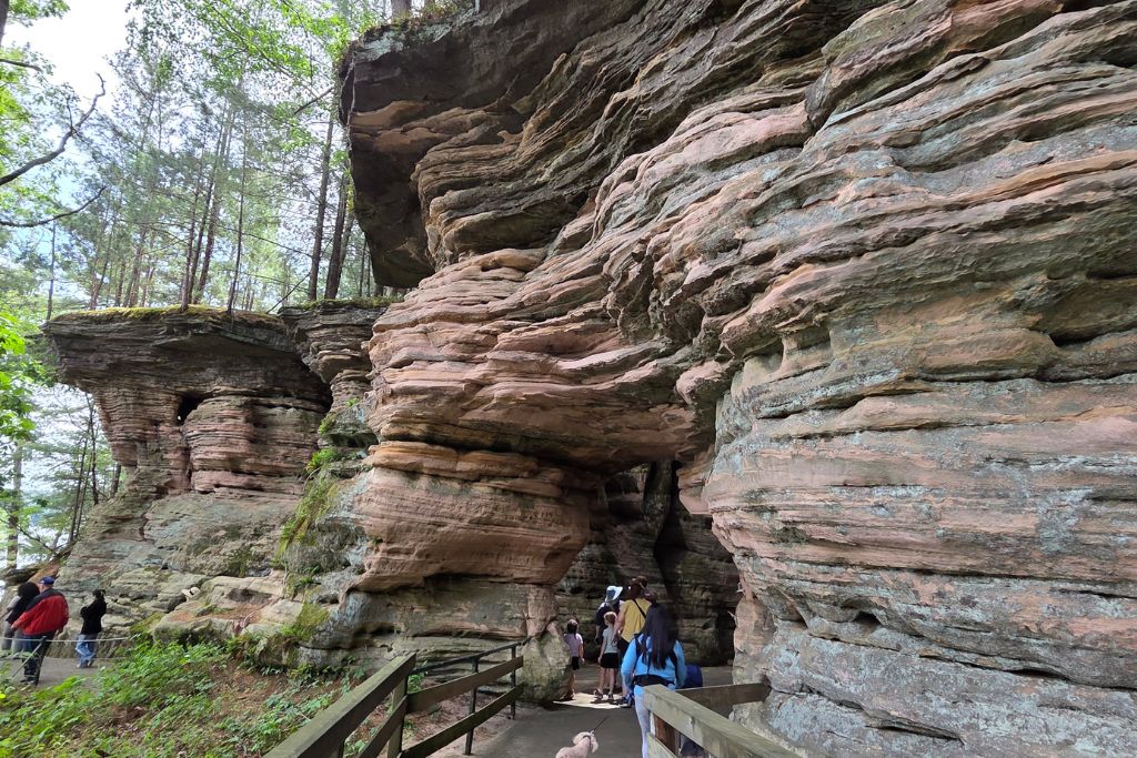 Wisconsin Dells For Adults: Beyond The Waterparks 6 Layered sandstone formations tower over the wooded walking trail at stand rock in wisconsin dells
