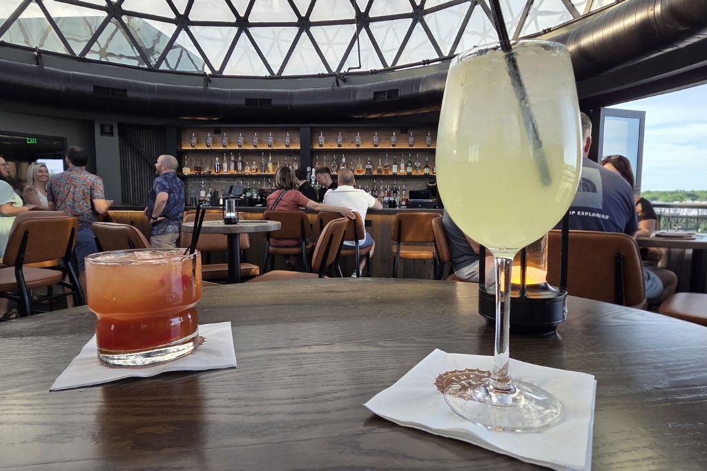 Wisconsin Dells For Adults: Beyond The Waterparks 2 Two cocktails sit on a table beneath the glass dome at silo rooftop bar in wisconsin dells.