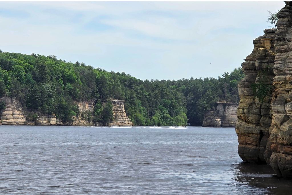 Wisconsin Dells For Adults: Beyond The Waterparks 20 The wisconsin river stretches between tall layered sandstone cliffs and dense green forest in wisconsin dells. The wide river landscape captures the scenery that made us want to return and experience more of the dells.