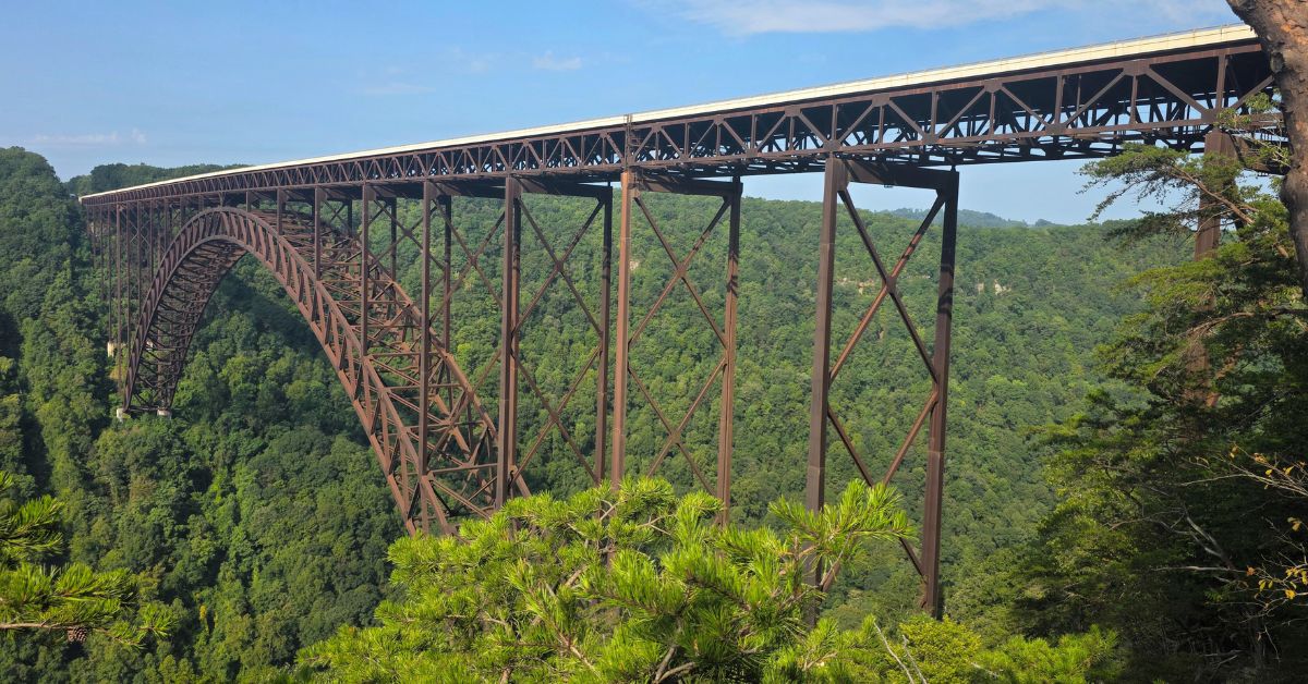 New River Gorge Bridge spanning a forested canyon for travelers exploring New River Gorge without hiking.