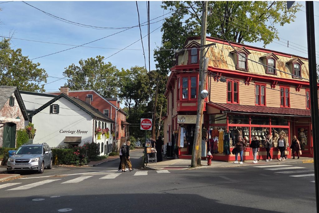 New Hope And Lambertville Fall Day Trip Guide 7 Pedestrians explore new hope main street lined with colorful historic buildings, boutique shops and restaurants on a fall day.