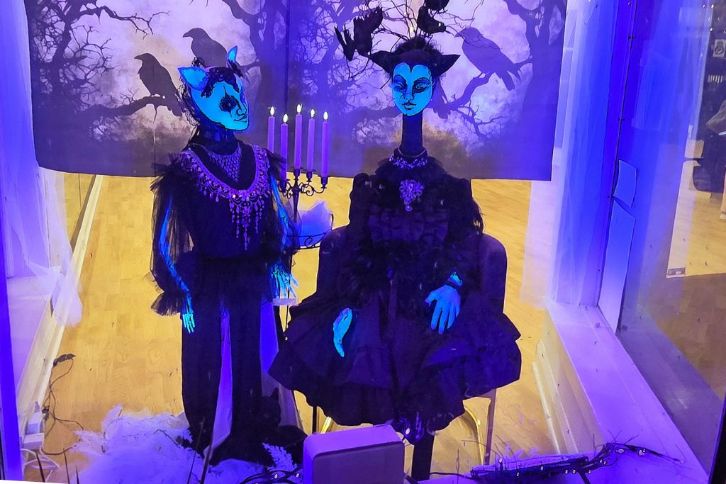 New Hope And Lambertville Fall Day Trip Guide 16 Two eerie blue faced figures in black dresses sit beneath a backdrop of ravens and bare trees in lambertville trail of magic.