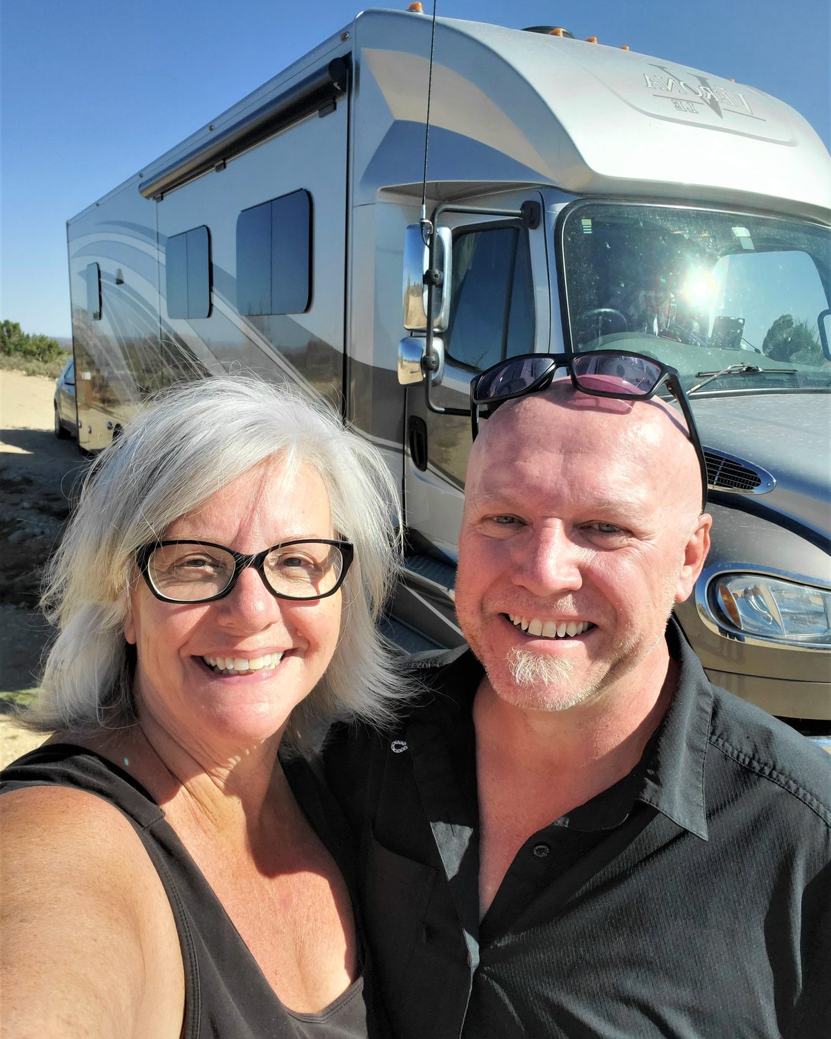 Robb and maureen smiling in front of their rv